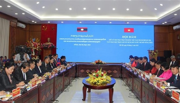 Hanoi, Vientiane share experience in front affairs